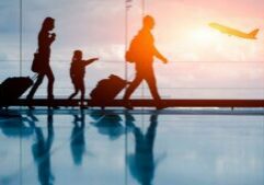 H4BF96 Silhouette of young family and airplane at airport